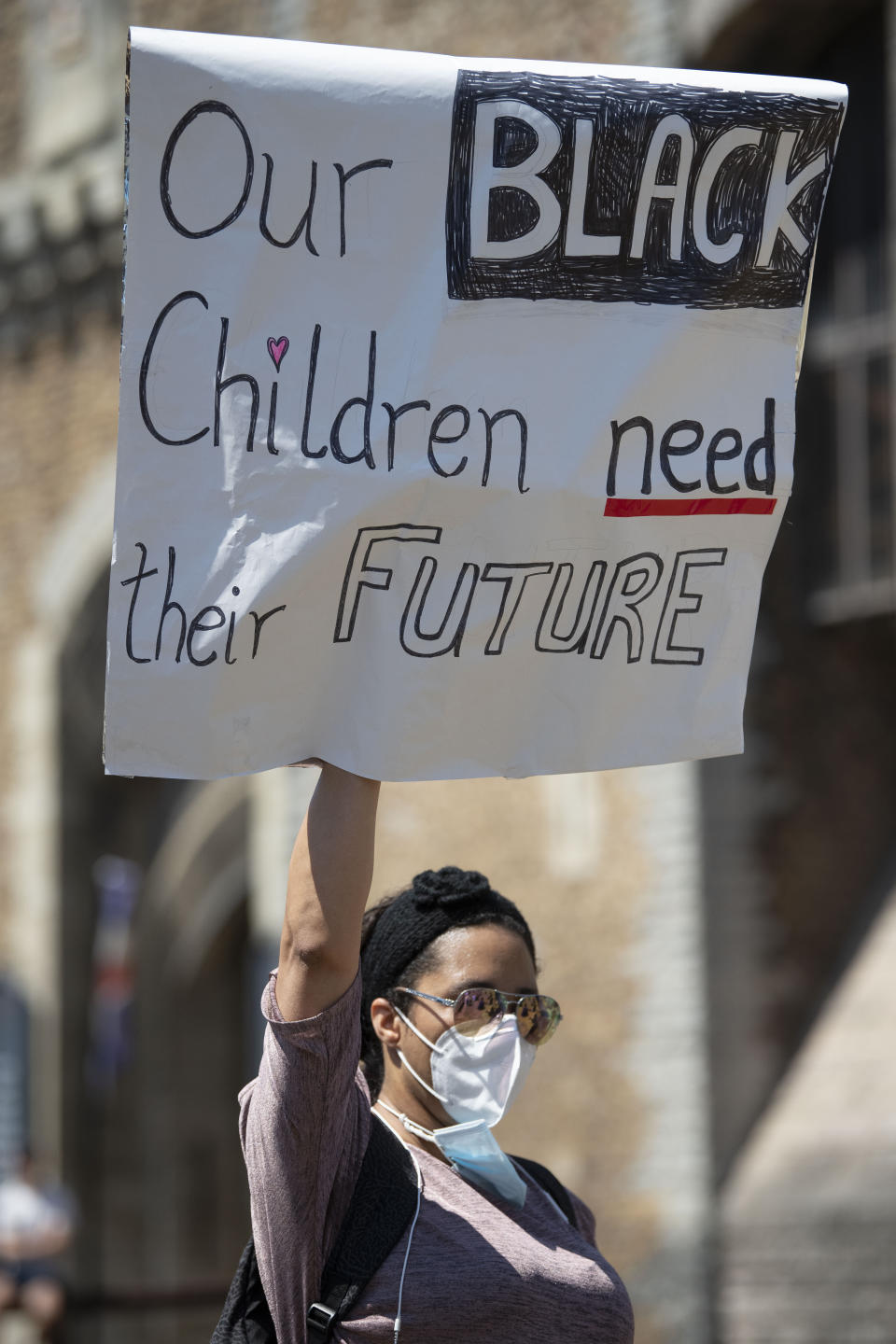 <i>A woman holds up a sign that says "Our black children need a future" during a May 31 protest outside Cardiff Castle in Wales/</i>