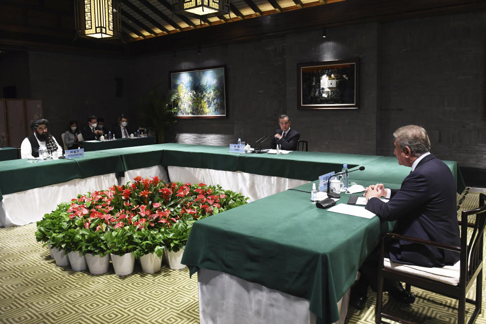 In this photo released by Xinhua News Agency, Chinese Foreign Minister Wang Yi center hosts a meeting with Pakistan Foreign Minister Shah Mahmood Qureshi at right and Taliban-appointed Afghanistan Foreign Minister Amir Khan Muttaqi at left held in Tunxi district in eastern China's Anhui province on Wednesday, March 30, 2022. Chinese leader Xi Jinping on Thursday issued strong backing for Afghanistan at a regional conference, while making no mention of human rights abuses by the country's Taliban leaders. (Zhou Mu/Xinhua via AP)