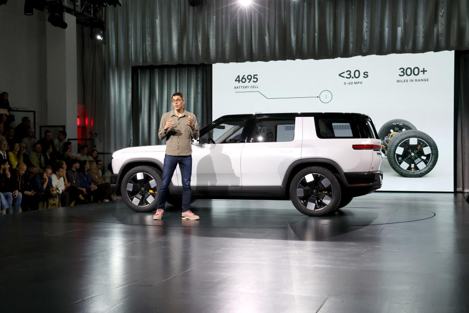 LAGUNA BEACH, CA - MARCH 07: Rivian Founder and CEO RJ Scaringe speaks on stage during the Rivian Reveals All-Electric R2 Midsize SUV event at Rivian South Coast Theater on March 07, 2024 in Laguna Beach, California.  (Photo by Philip Faraone/Getty Images for Rivian)