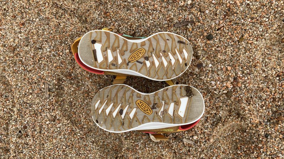 Soles of hiking sandals lying on the beach