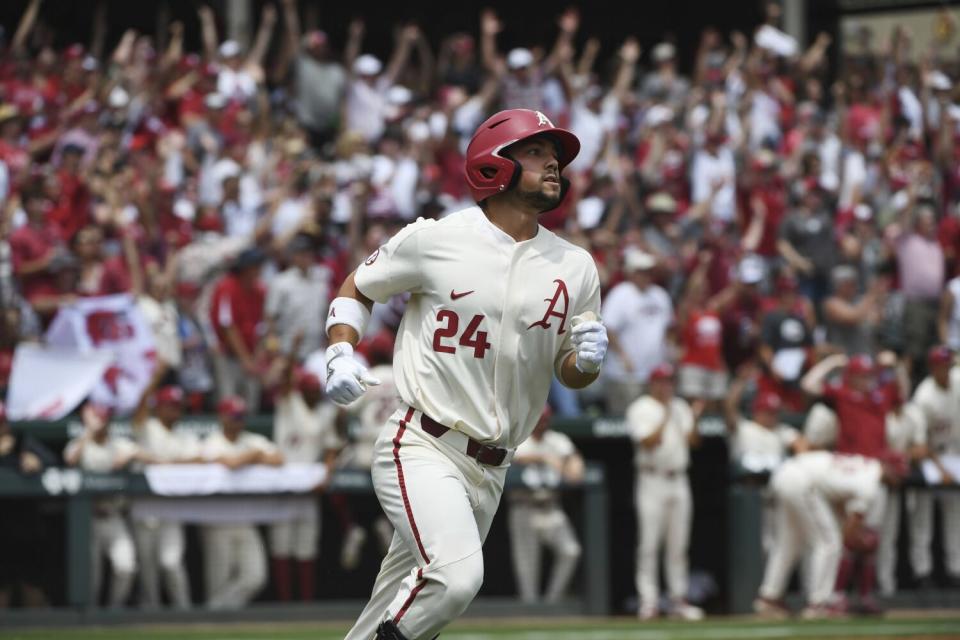 Arkansas' Dominic Fletcher hits a home run against Mississippi during an NCAA super regional tournament on June 9, 2019.