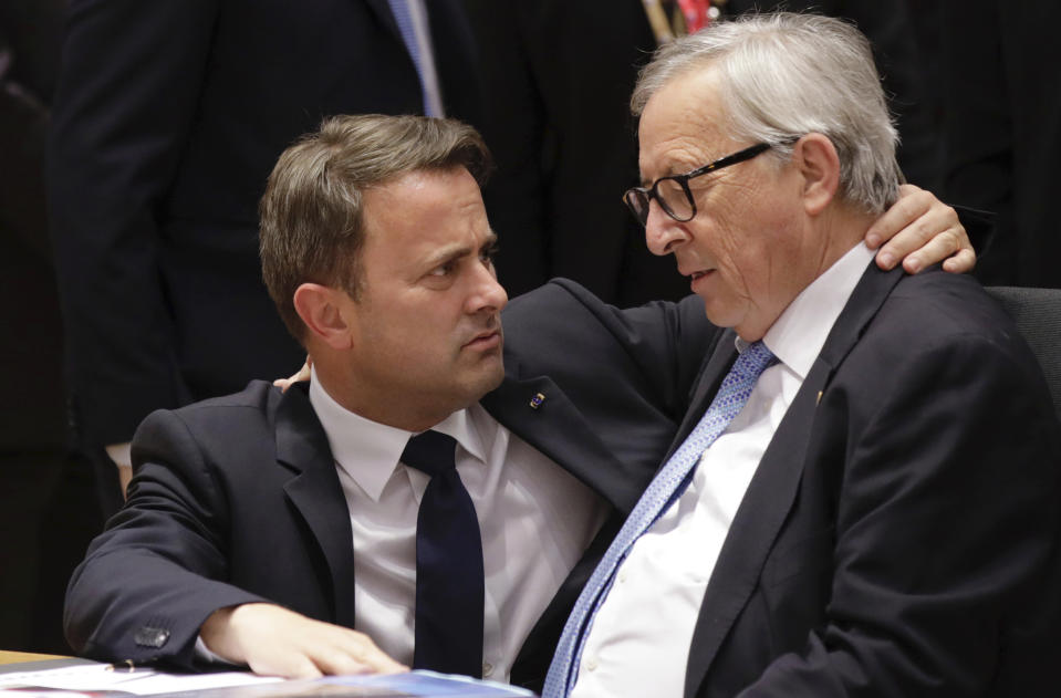 FILE - In this Thursday, June 20, 2019 file photo, Luxembourg's Prime Minister Xavier Bettel, left, speaks with European Commission President Jean-Claude Juncker during a round table meeting at an EU summit in Brussels. Luxembourg on Monday, Feb. 8, 2021 denied claims, made in various international media outlets, that Luxembourg is still a massive tax haven despite European Union legislation to clamp down on it. (AP Photo/Olivier Matthys, File)