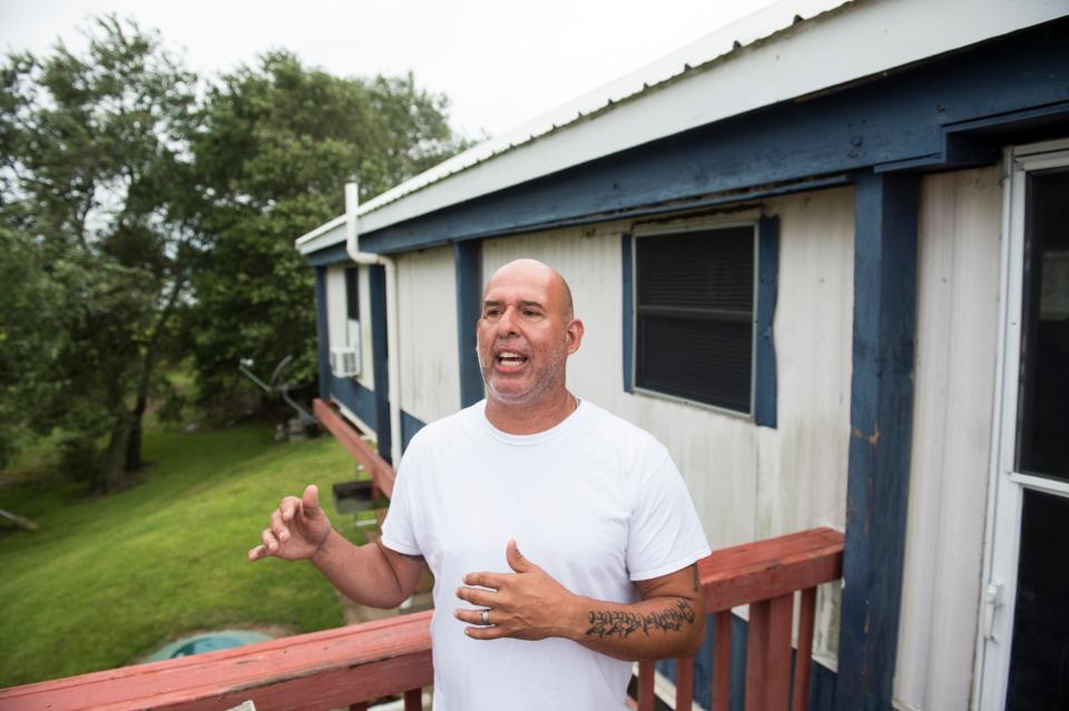Anthony Verdun talks from his porch where he will ride out Tropical Storm Barry in Isle de Jean Charles, La., on Friday, July 12, 2019. Isle de Jean Charles is slowly shrinking due to rising sea levels. 