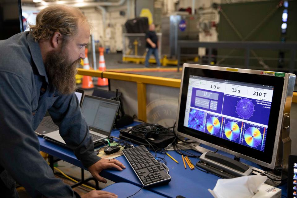 Florida Institute of Technology professor J. Travis Hunsucker monitors waves and sea states this week aboard the USS Portland as the ship made its way to the Orion recovery site in the Pacific Ocean.