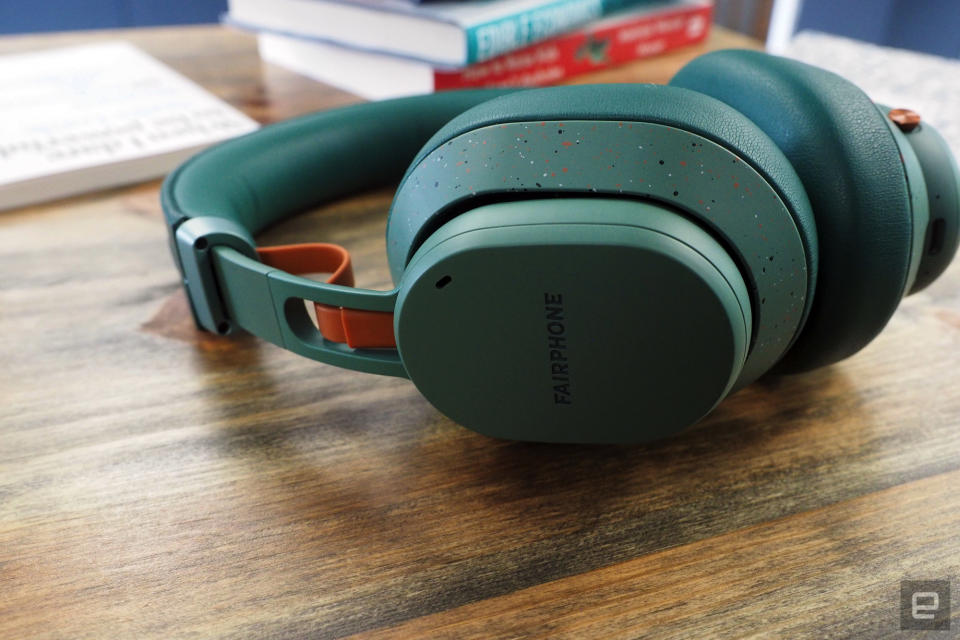 Image of Fairphone's Fairbuds XL on a table surrounded by books.