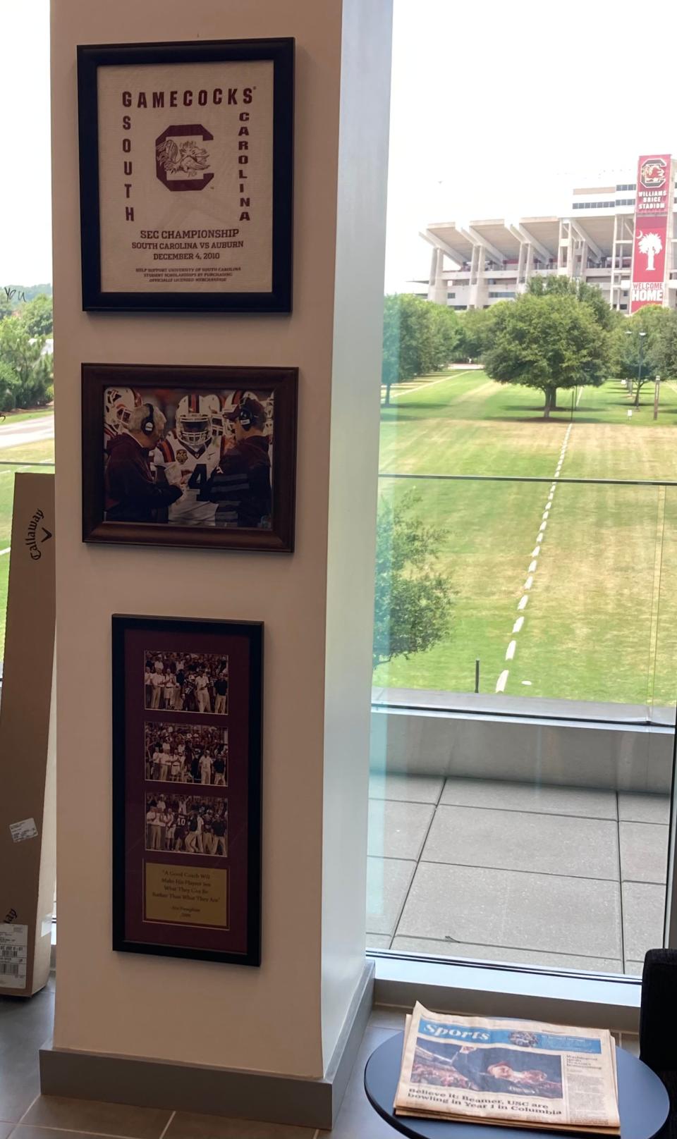 A photo in Shane Beamer's South Carolina office shows him coaching at Virginia Tech with his dad, Frank Beamer, during the 2011 ACC Championship Game. Between them in the photo is Hokies running back David Wilson. Above that photo is a white towel from South Carolina's 2010 appearance in the SEC Championship. Shane Beamer was an assistant on Steve Spurrier's staff that season.