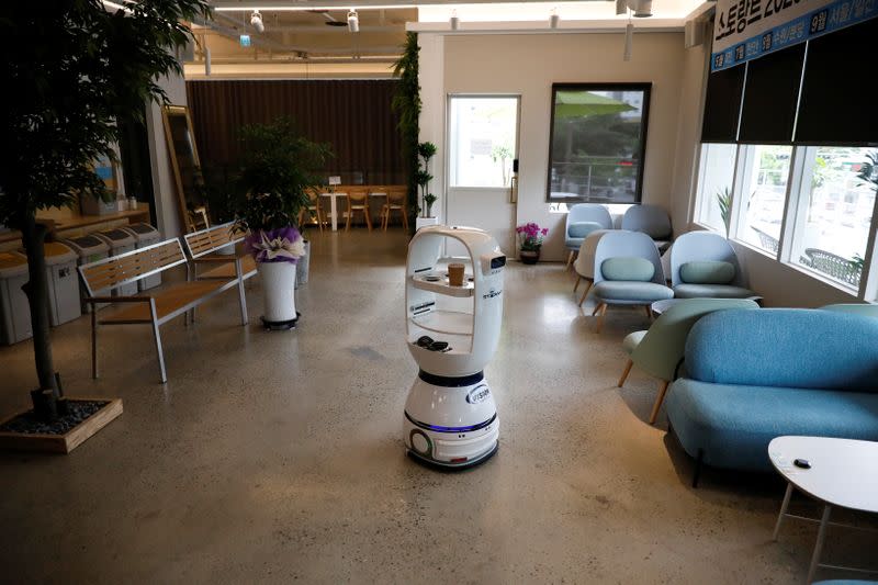 A robot that takes orders, makes coffee and brings the drinks straight to customers at their seats is seen at a cafe in Daejeon