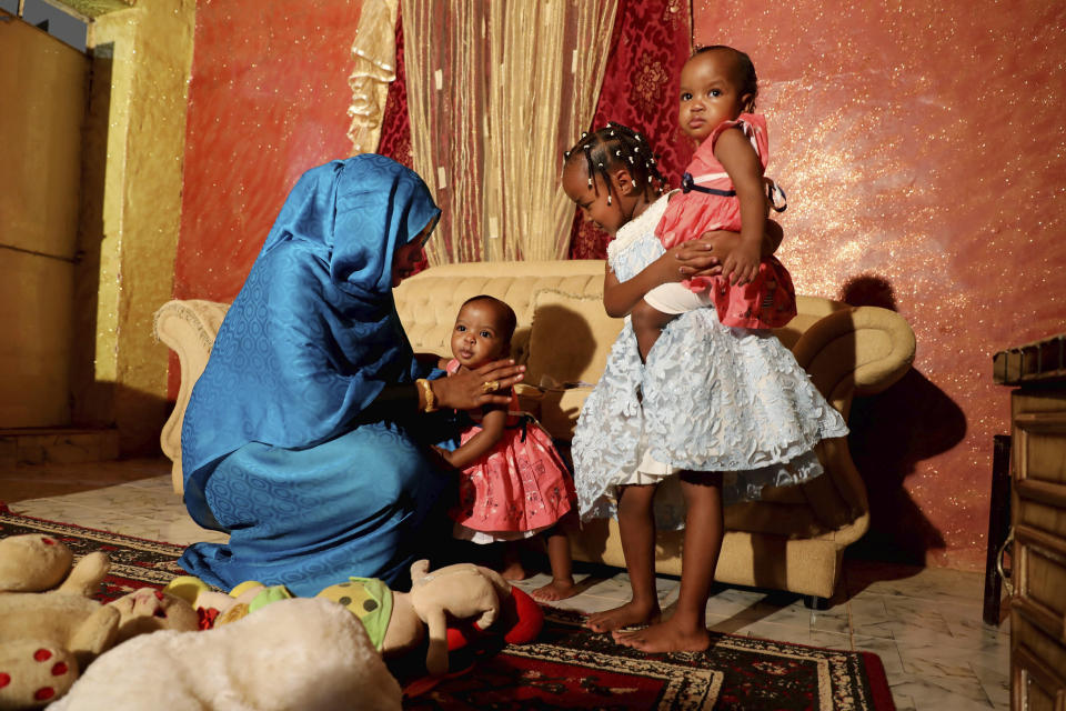 Youssria Awad plays with her daughters in their home, in Khartoum, Sudan on June 14, 2020. She refuses to carry out female genital mutilation on them, a practice that involves partial or total removal of the external female genitalia for non-medical reasons that The World Health Organization says FGM constitutes an "extreme form of discrimination" against women. (AP Photo/Marwan Ali)