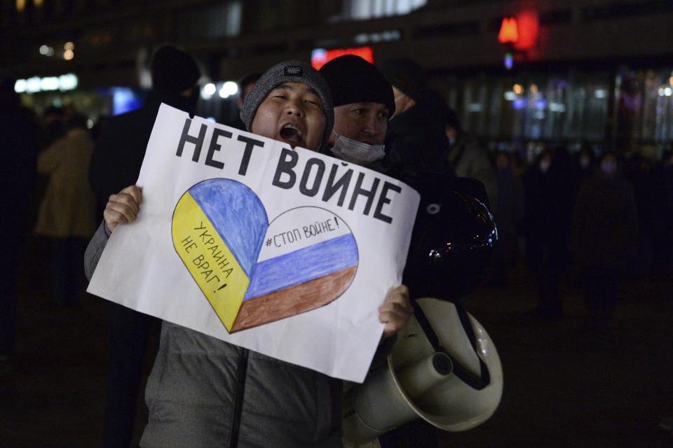 FILE - Police officer detain a demonstrator with the poster reading "No war" during an action against Russia's attack on Ukraine in Moscow, Russia, Thursday, Feb. 24, 2022. Eight months after Russian President Vladimir Putin launched an invasion against Ukraine expecting a lightening victory, the war continues, affecting not just Ukraine but also exacerbating death and tension in Russia among its own citizens. (AP Photo/Denis Kaminev, File)