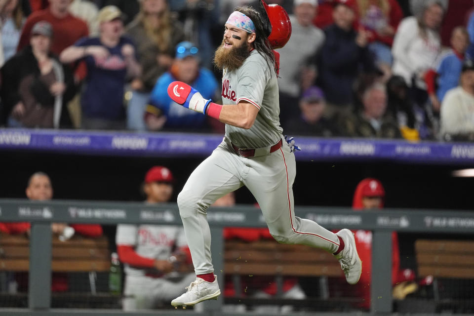 Philadelphia Phillies' Brandon Marsh rounds third base on the way to scoring on a triple by Edmundo Sosa off Colorado Rockies relief pitcher Justin Lawrence during the ninth inning of a baseball game Saturday, May 25, 2024, in Denver. (AP Photo/David Zalubowski)