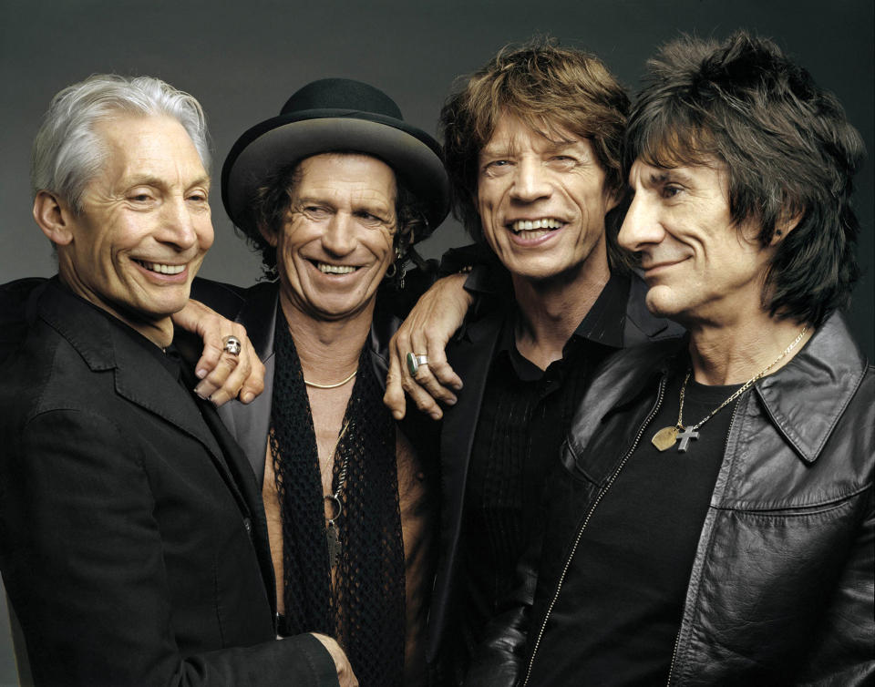 FILE - This 2005 file photo, originally supplied by the Rolling Stones, shows members of the group, from left, Charlie Watts, Keith Richards, Mick Jagger, and Ron Wood posing during a photo shoot. The Rolling Stones have called off their tour dates in Australia and New Zealand following the death of Mick Jagger’s girlfriend and designer L’Wren Scott on Monday, March 17, 2014. The iconic band says in a statement Tuesday they “are deeply sorry and disappointed to announce the postponement of the rest of their 14 ON FIRE tour.” (AP Photo/The Rolling Stones, Mark Seliger-File)