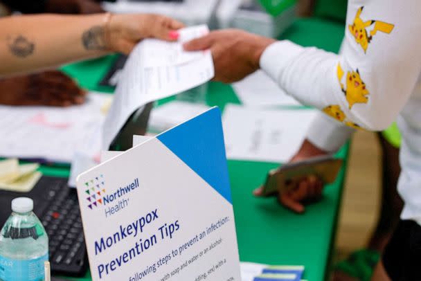 PHOTO: A sign lists monkeypox prevention tips, next to a person arriving to receive a monkeypox vaccination at the Northwell Health Immediate Care Center, in New York, July 15, 2022.  (Eduardo Munoz/Reuters)