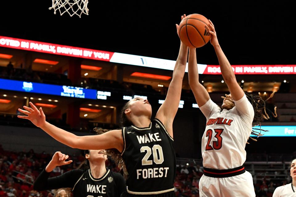 Wake Forest forward Olivia Summiel (20) battles Louisville guard Chelsie Hall (23) for a rebound during the first half of an NCAA college basketball game in Louisville, Ky., Sunday, Jan. 23, 2022. (AP Photo/Timothy D. Easley)