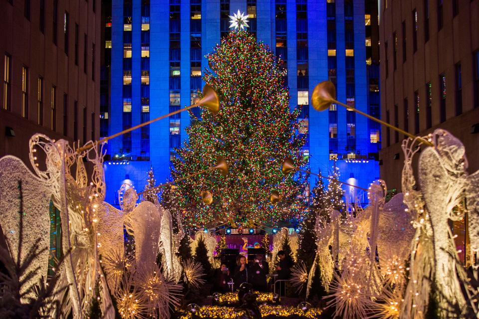 The Rockefeller Center Christmas tree stands lit as people take photos of it and the holiday decorations at Rockefeller Center during the 85th annual Rockefeller Center Christmas tree lighting ceremony, Wednesday, Nov. 29, 2017, in New York.