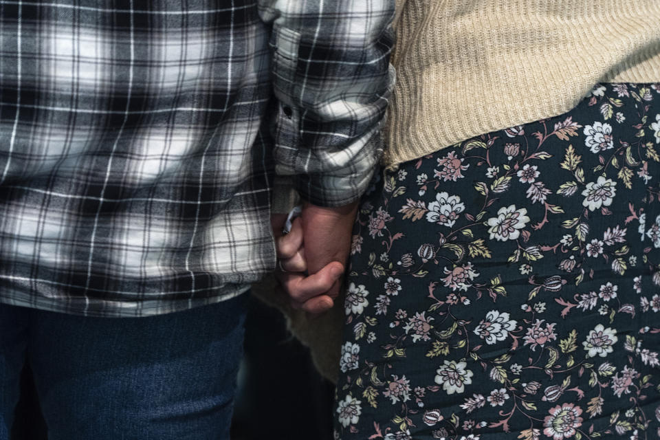 Family members of victims hold hands following a news conference on Friday, May 17, 2024, in Portland, Ore., after a grand jury indicted Jesse Lee Calhoun on second-degree murder charges in the deaths of Charity Lynn Perry, 24; Bridget Leanne Webster, 31; and Joanna Speaks, 32. (AP Photo/Jenny Kane)