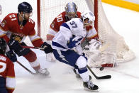 Florida Panthers goaltender Spencer Knight stops a shot on goal by Tampa Bay Lightning center Yanni Gourde (37) during the third period in Game 5 of an NHL hockey Stanley Cup first-round playoff series, Monday, May 24, 2021, in Sunrise, Fla. (AP Photo/Lynne Sladky)