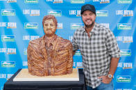 <p>Luke Bryan poses with a statue of himself made entirely of Farmland bacon at his Farm Tour 2021 stop in Marshall, Wisconsin, on Sept. 6.</p>