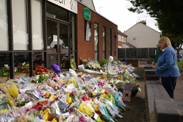 A woman looks at the floral tributes left outside the Belfairs Methodist Church in Leigh-on-Sea, Essex, where Conservative MP Sir David Amess was killed on Friday