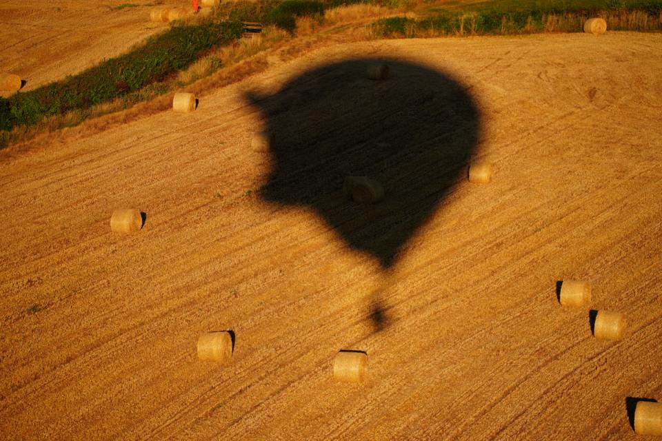 A balloon casts a shadow over a farmer’s field (Ben Birchall/PA) (PA Wire)