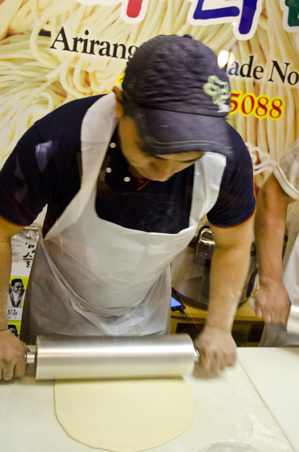 A worker prepares the dough he will later knife-cut into handmade noodles at Arirang.