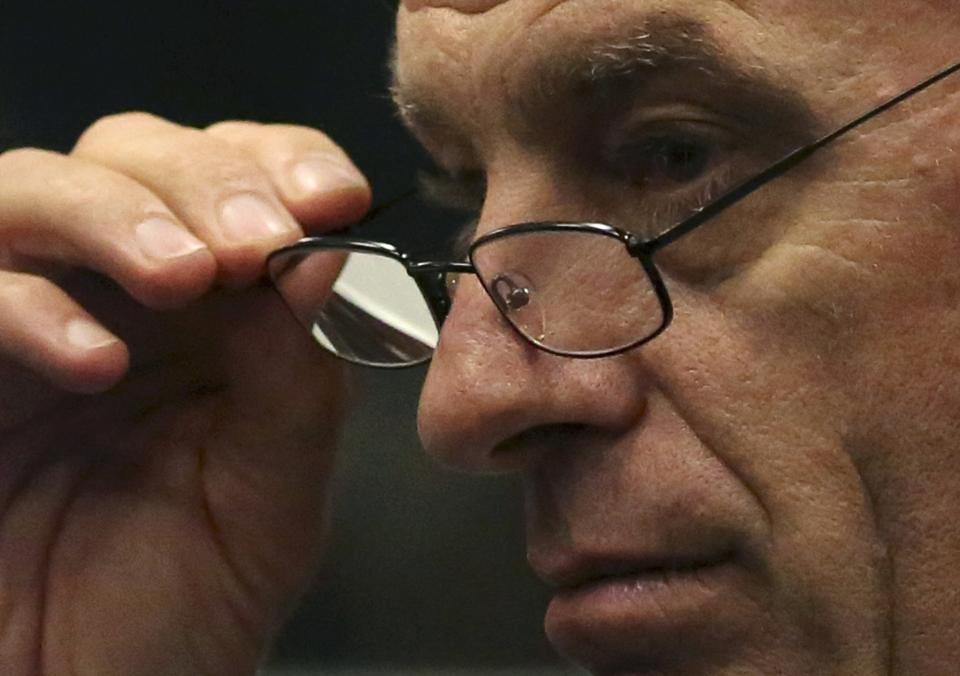 State prosecutor Gerrie Nel gestures as he cross-examines Olympic and Paralympic sprinter Oscar Pistorius during his trial at North Gauteng High Court in Pretoria April 15, 2014. Pistorius is on trial for killing his girlfriend Reeva Steenkamp at his suburban Pretoria home on Valentine's Day last year. He said he mistook her for an intruder. REUTERS/Siphiwe Sibeko (SOUTH AFRICA - Tags: CRIME LAW HEADSHOT)