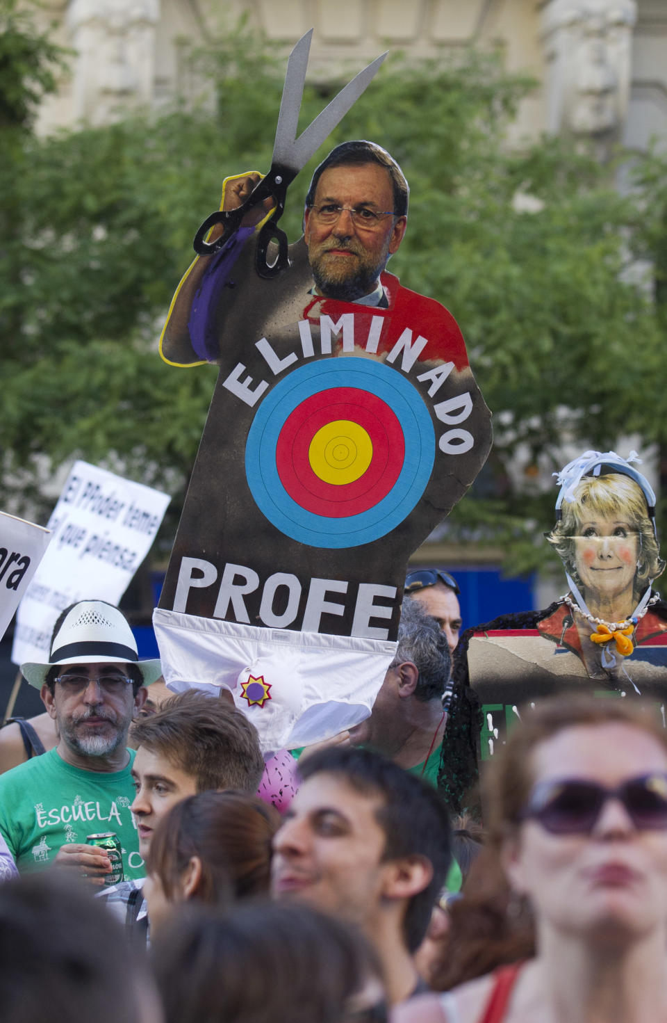 Protesters hold up an effigy of Spain's Prime Minister Mariano Rajoy holding a large pair of scissors during a demonstration against education cuts in Madrid Tuesday May 22, 2012. Teachers and students from every level of Spain's education system went on strike Tuesday to protest wide-ranging government spending cuts. The impact of the budget cuts has been brutal, however, and unemployment has swelled to nearly 25 percent. Among people under age 25 it is a staggering 52 percent. The situation is likely to get worse before it improves, with the economy in its second recession in three years and the full impact of new austerity measures yet to hit the country. Spanish words on effigy read ' Teachers eliminated'. (AP Photo/Paul White)