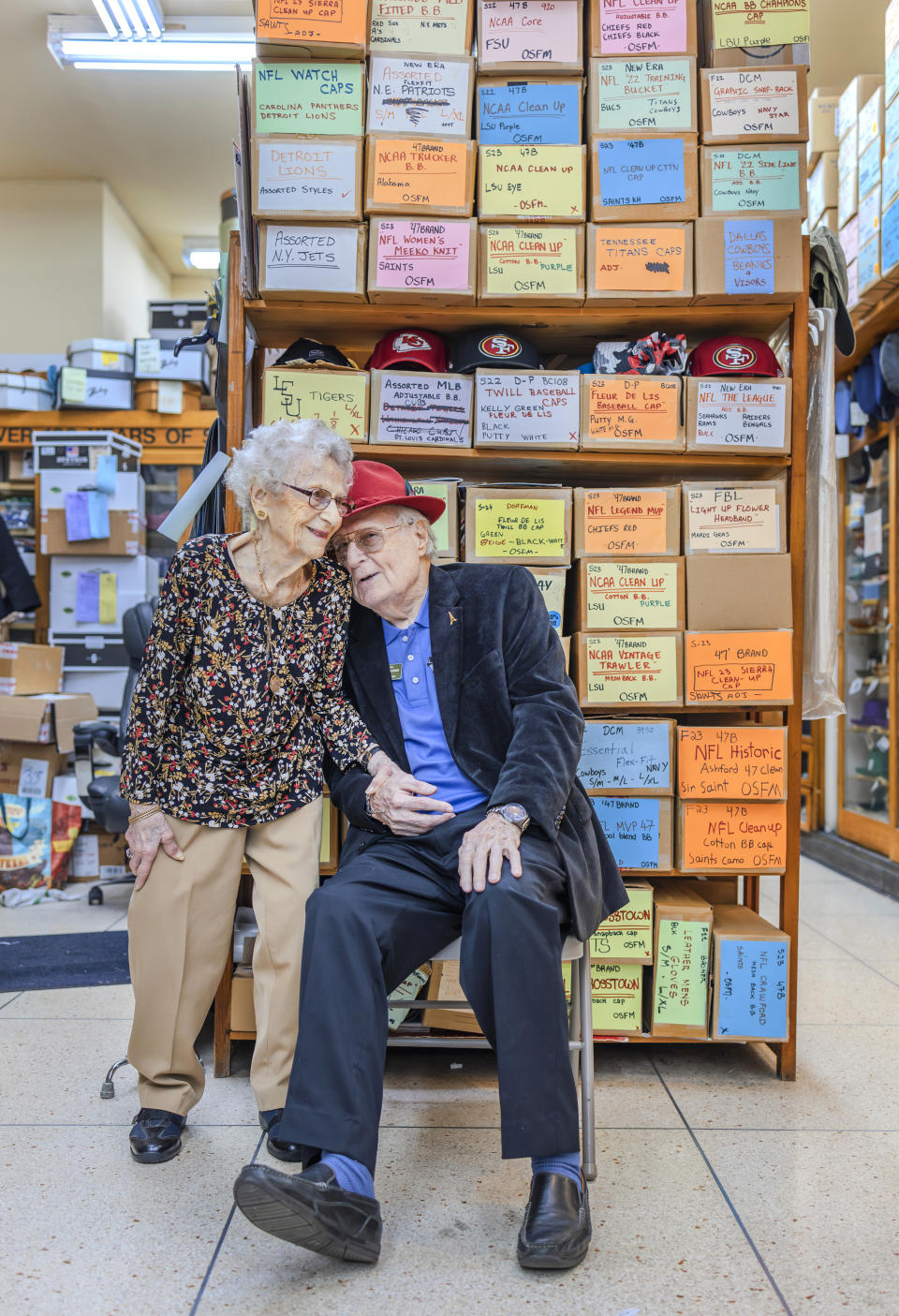 Sam Meyer and his wife, Marcelle, take a rare break inside Meyer the Hatter in downtown New Orleans on Friday, Feb. 23, 2024. Meyer was awarded the rank of chevalier, or knight, of the National Order of the Legion of Honor. (Chris Granger/The Times-Picayune/The New Orleans Advocate via AP)