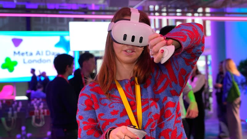 A visitor tries out a Meta Quest 3 headset at the Meta AI Day in London, Tuesday, April 9, 2024. Meta — the parent company to Facebook — is launching a product later this year for its Quest VR headsets used in classrooms.