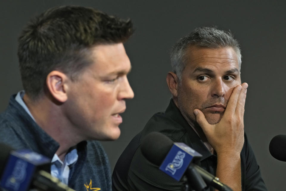 Tampa Bay Rays manager Kevin Cash, right, looks on as Erik Neander, President of Baseball Operations, speaks during a season ending baseball news conference Monday, Oct. 9, 2023, in St. Petersburg, Fla. The Rays were swept by the Texas Rangers in the wild card round. (AP Photo/Chris O'Meara)