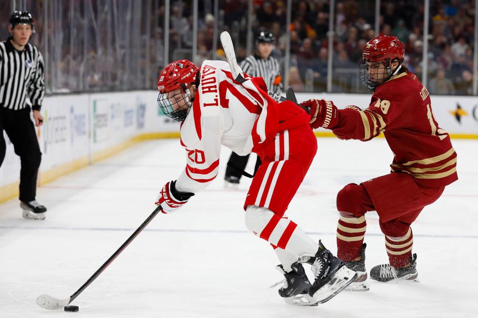 BOSTON, MA - FEBRUARY 05: Cutter Gauthier #19 of the Boston College Eagles gets his stick up on Lane Hutson #20 of the Boston University Terriers while trying to stop him during the first period of the semifinals of the Beanpot Tournament at TD Garden on February 5, 2024 in Boston, Massachusetts. (Photo By Winslow Townson/Getty Images)