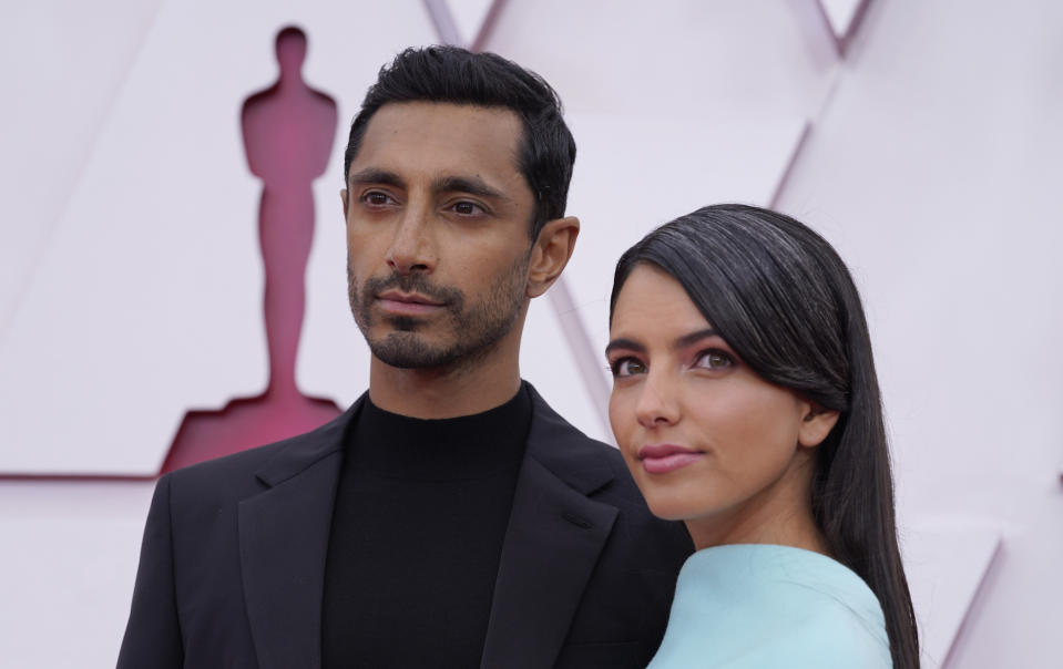 Riz Ahmed, left, and Fatima Farheen Mirza arrive at the Oscars on Sunday, April 25, 2021, at Union Station in Los Angeles. (AP Photo/Chris Pizzello, Pool)