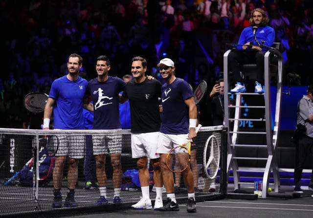 Andy Murray, Novak Djokovic, Roger Federer and Rafael Nadal with arms round each other posing for a photograph at the net of an indoor tennis court