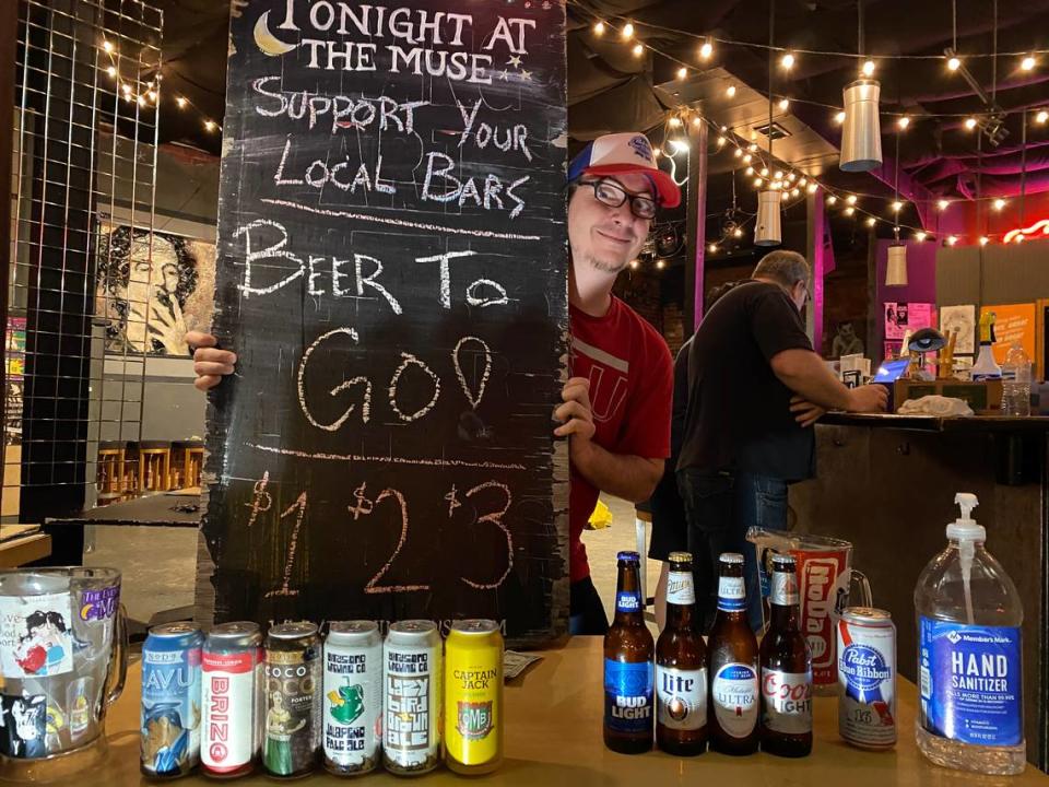 Chris Koster sells beers in the doorway of The Evening Muse on March 20, 2020.