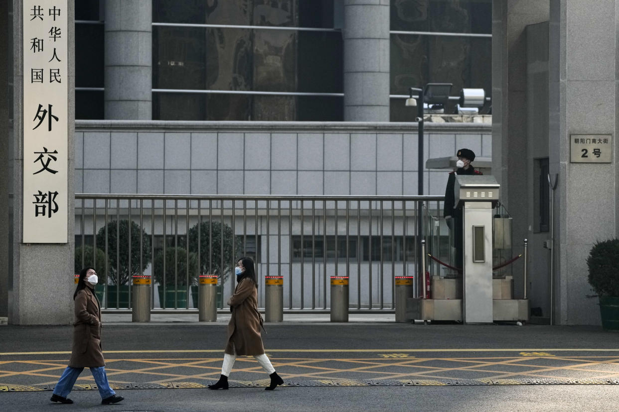 Women wearing face masks walk by the main entrance gate of the Ministry of Foreign Affairs office in Beijing, Monday, Deb. 6, 2023. China on Monday accused the United States of indiscriminate use of force when the American military shot down a suspected Chinese spy balloon Saturday, saying that had "seriously impacted and damaged both sides' efforts and progress in stabilizing Sino-U.S. relations." (AP Photo/Andy Wong)