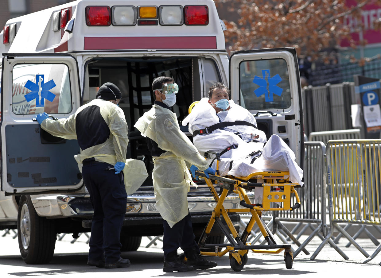 A patient is wheeled out of Elmhurst Hospital Center to a waiting ambulance, Tuesday, April 7, 2020, in the Queens borough of New York, during the current coronavirus outbreak. (Kathy Willens/AP)