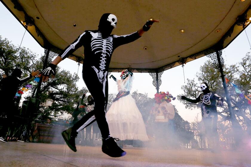 Los Angeles, CA - Dancers in skeleton costues dance at Olvera Plaza during Day of the Dead festivities at Olvera Plaza in Los Angeles on Wednesday, Nov. 1, 2023. (Luis Sinco / Los Angeles Times)