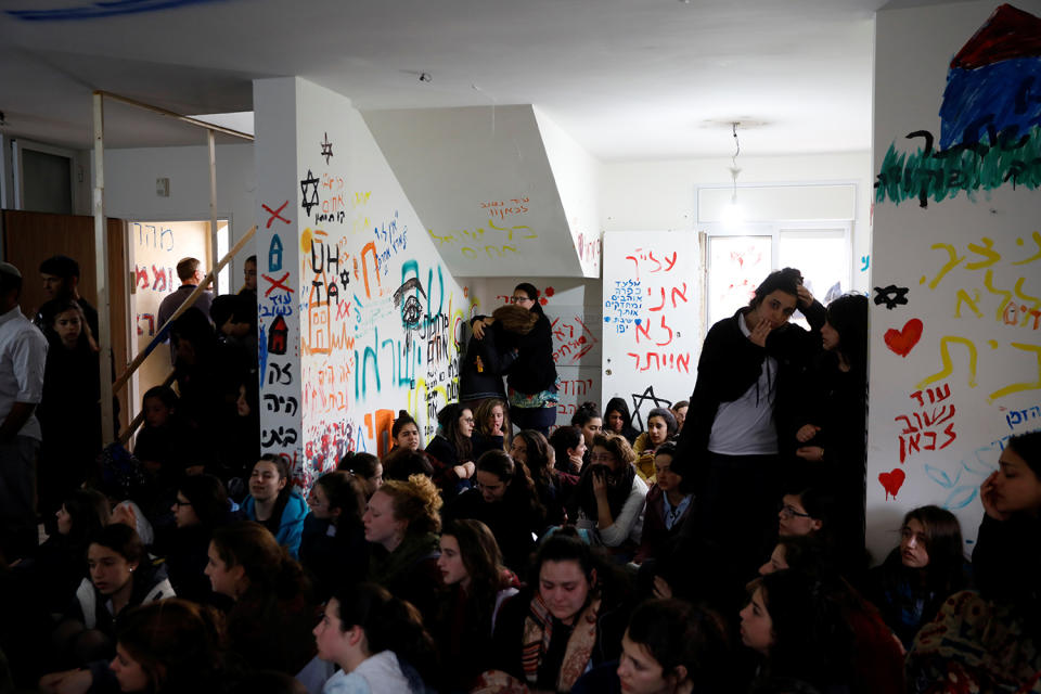 Pro-settlement activists gather inside a house to resist evacuation of some houses in the settlement of Ofra in the occupied West Bank, during an operation by Israeli forces to evict the houses