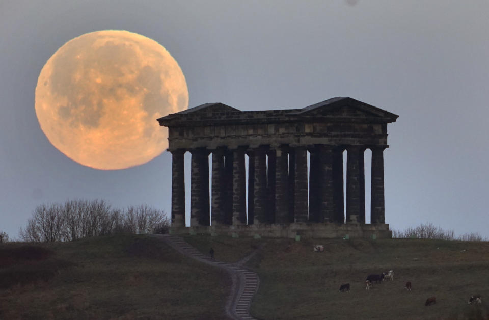 The December full moon sets behind the Penshaw Monument, near Sunderland. Elsewhere in the UK, the Met Office issued fresh warnings for snow for Wednesday, with the potential to cause rail and road closures, power cuts, and injuries.