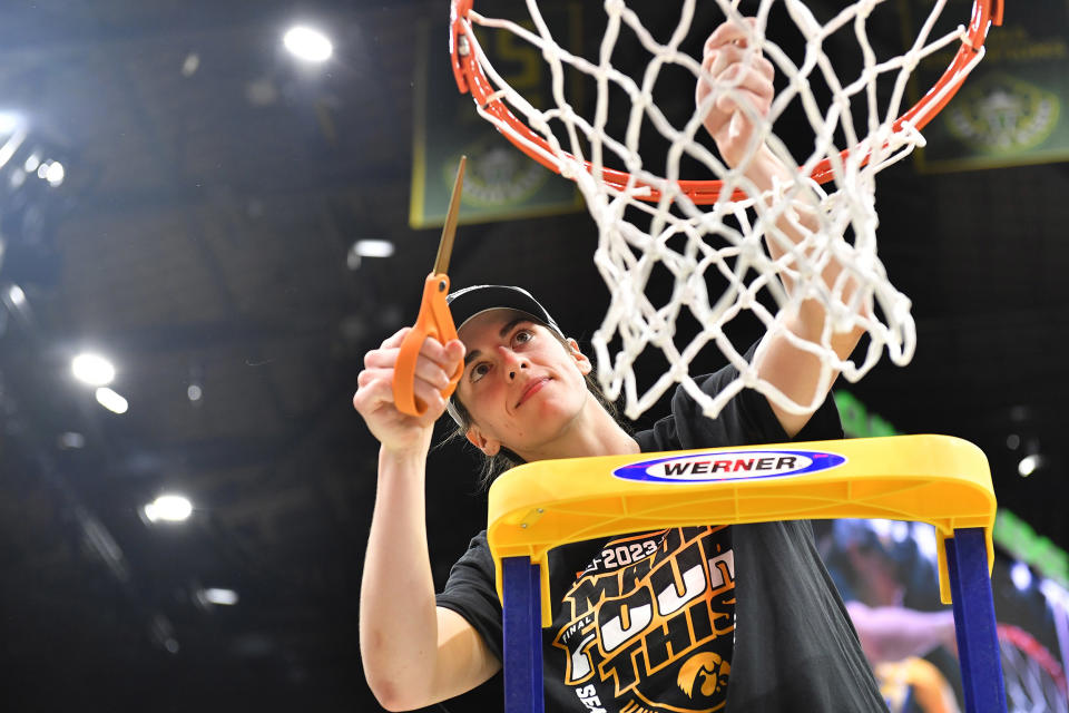 Caitlin Clark cuts the net after Iowa's Elite 8 win over Louisville (Alika Jenner / Getty Images)