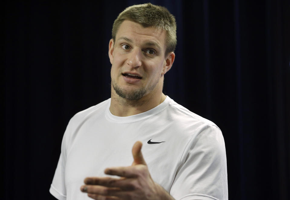 FILE - In this Nov. 28, 2018, file photo, New England Patriots tight end Rob Gronkowski speaks to the media after an NFL football practice in Foxborough, Mass. Gronkowski will be in Miami for the Super Bowl. He will not be preparing for kickoff with Tom Brady and the rest of his old New England teammates. Instead, the man who retired from the Patriots and the NFL in March will be hosting his first Super Bowl party. (AP Photo/Steven Senne, File)