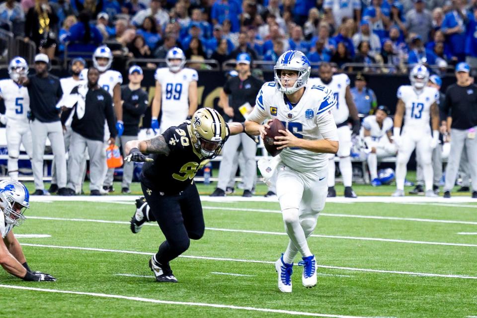Lions quarterback Jared Goff scrambles out the pocket against Saints defensive end Carl Granderson during the first half of the Lions' 33-28 win on Sunday, Dec. 3, 2023, in New Orleans.