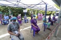 Health workers wait to receive the Covishield COVID-19 vaccine at the Ayeyarwaddy COVID treatment center Wednesday, Jan. 27, 2021, in Yangon, Myanmar. Health workers in Myanmar on Wednesday became the country's first people to get vaccinated against COVID-19, just five days after the first vaccine supply was delivered from India. (AP Photo/Thein Zaw)