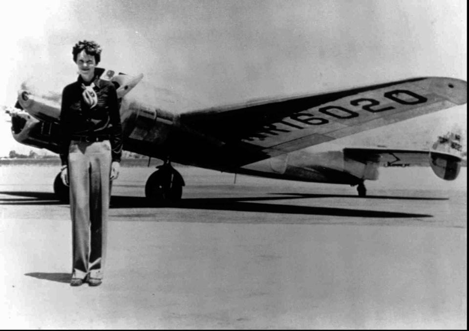 Amelia Earhart, 40, stands next to a Lockheed Electra 10E, before her last flight in 1937.