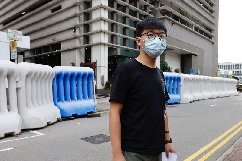 Pro-democracy activist Joshua Wong leaves a police station after being arrested for participating in an unauthorized assembly last year, in Hong Kong