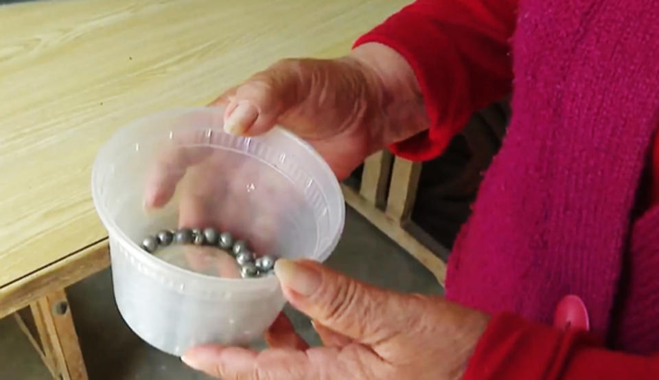An Azusa resident holds ball bearings she says were shot at her house over the years. (KNBC)