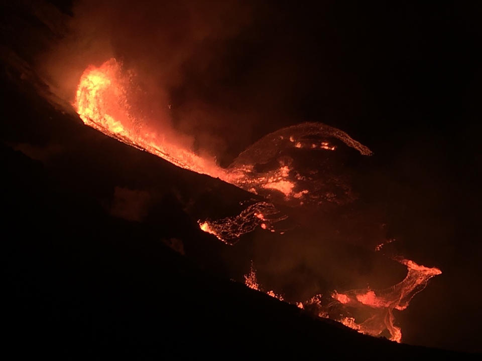 In this photo provided by the U.S. Geological Survey, lava flows within the Halema’uma’u crater of the Kilauea volcano Sunday, Dec. 20, 2020. The Kilauea volcano on Hawaii’s Big Island has erupted, the U.S. Geological Survey said. (U.S. Geological Survey via AP)