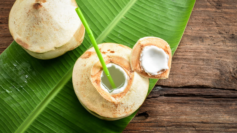 Fresh coconut with straw in it