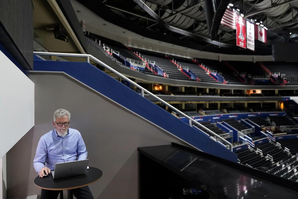 John Hair, director of Insights Centers at KPMG, works in a new business suite at Capital One Arena, home to NHL's Washington Capitals and NBA's Washington Wizards, Tuesday, June 7, 2022, in Washington. (AP Photo/Patrick Semansky)