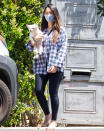 <p>Olivia Munn grabs her pup to head to the groomers out in L.A. on June 14.</p>