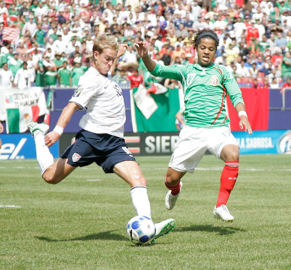 Jul 26, 2009; East Rutherford, NJ, USA; USA midfielder Stuart Holden (10) kicks the ball as Mexico forward Giovani Dos Santos (17) closes in during first half of the 2009 CONCACAF Gold Cup Championship at Giants Stadium.